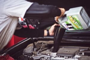 autoservis uchytil čakovice man refilling motor oil on car engine bay